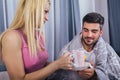 Woman taking care of her sick boyfriend at home Royalty Free Stock Photo