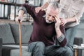 Woman taking care of senior husband with strong headache Royalty Free Stock Photo