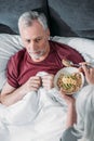 Woman taking care of sick husband in bed at home Royalty Free Stock Photo