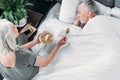 Woman taking care of sick husband in bed at home Royalty Free Stock Photo