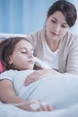 Woman taking care of sick younger sister during stay in a private clinic