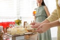 Woman taking delicious zephyr at baby shower party, closeup