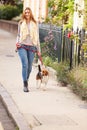 Woman Taking Dog For Walk On City Street Royalty Free Stock Photo