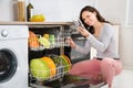 Woman Taking Drinking Glass From Dishwasher