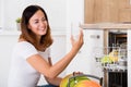 Woman Taking Drinking Glass From Dishwasher Royalty Free Stock Photo