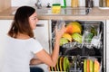 Woman Taking Drinking Glass From Dishwasher Royalty Free Stock Photo