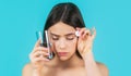 Woman taking drugs to releave headache. Woman taking pill against headache. Brunette take some pills, holds glass of Royalty Free Stock Photo