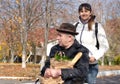 Woman taking an elderly disabled man shopping