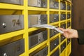 Woman taking envelopes out of mailbox in post office, closeup Royalty Free Stock Photo