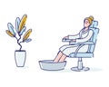 Woman taking foot bath. Relaxed female enjoying spa procedure for legs care