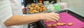 Woman taking freshly baked home made cookies from the tray Royalty Free Stock Photo