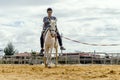 A woman taking horse riding lessons in a paddock Royalty Free Stock Photo