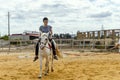 A woman taking horse riding lessons in a paddock Royalty Free Stock Photo