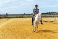 A woman taking horse riding lessons in a paddock Royalty Free Stock Photo