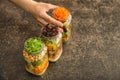 Woman taking mason jar with tasty vegetable salad