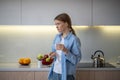 Woman taking medication vitamins dietary supplements standing on kitchen at home. Royalty Free Stock Photo