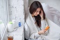 Woman taking medicine. Beautiful girl holding blister pack with pills in hand. Ill woman feels a headache and holds her Royalty Free Stock Photo