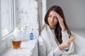 Woman taking medicine. Beautiful girl holding blister pack with pills in hand. Ill woman feels a headache and holds her Royalty Free Stock Photo