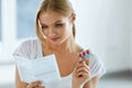 Woman Taking Medicine. Female With Pills Reading Instructions Royalty Free Stock Photo