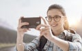 Woman taking nature photos with her phone Royalty Free Stock Photo