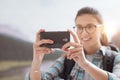 Woman taking nature photos with her phone Royalty Free Stock Photo