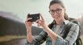 Woman taking nature photos with her phone Royalty Free Stock Photo