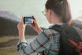 Woman taking nature pictures with her phone Royalty Free Stock Photo