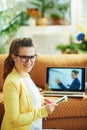 Woman taking notes in notebook at modern home in sunny day Royalty Free Stock Photo