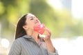 Woman taking off mask breathing fresh air outdoors