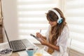 Woman taking online course writing in planner Royalty Free Stock Photo