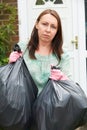 Woman Taking Out Garbage In Bags Royalty Free Stock Photo