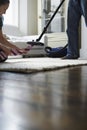 Woman Taking Out Tie From Vacuum Cleaner Royalty Free Stock Photo