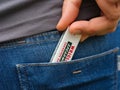 A woman taking a pack of Wrigley\'s spearmint gum out of a back jeans pocket