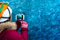 Woman taking photo in blue ice cave in Iceland Royalty Free Stock Photo