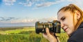 Woman taking a photo with a camera high in the sky flying in a hot air balloon