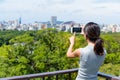 Woman taking photo on cellphone in Fukuoka city Royalty Free Stock Photo