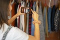 Woman taking a photo with her mobile of the wardrobe. Photograph the closet.