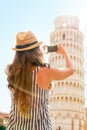 Woman taking photo of leaning tower of pisa, italy Royalty Free Stock Photo