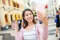 Woman taking photo by mobile phone in Macau Royalty Free Stock Photo