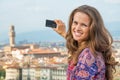 Woman taking photo of panoramic view of florence
