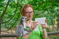 Woman taking photo selfie with ring tailed lemur Royalty Free Stock Photo