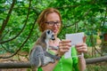 Woman taking photo selfie with ring tailed lemur Royalty Free Stock Photo