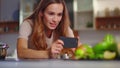 Woman taking photo on smartphone of fruit composition at kitchen Royalty Free Stock Photo