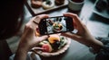 Woman taking a photo of sushi rolls with smart phone in a restaurant