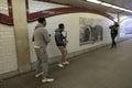 Woman taking a photo of two street entertainers.