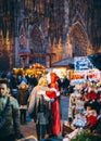 Woman taking photograph with Santa during Christmas Market