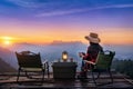 Woman taking photos with camera while camping at sunrise. Doi Luang Chiang Dao mountains in Chiang Mai Royalty Free Stock Photo