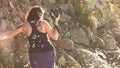 Woman taking a photos with dslr camera outdoors, on the beach