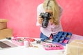 Woman taking photos of her own created merchandise, sells them online and mails packages to buyers