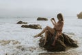 Woman taking photos with her phone on the beach Royalty Free Stock Photo